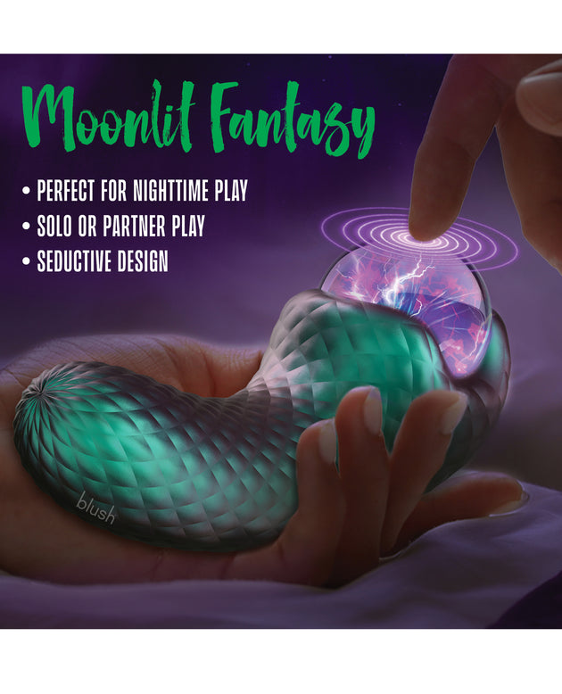 Glowing green and pink toy with text on a dark background